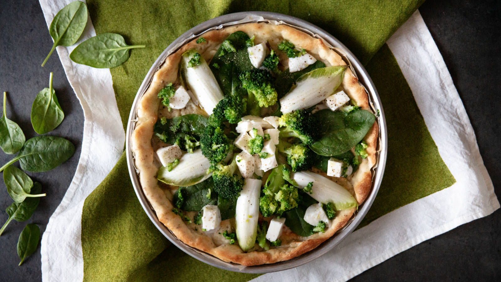 Pizza integrale con mozzarella cruda, broccoli, indivia e spinaci